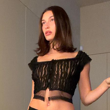 Hailey bieber wears a black cropped going-out top.