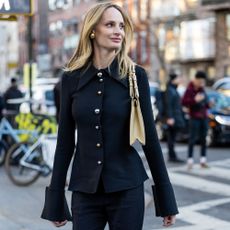 Lauren Santo Domingo wears a black sweater