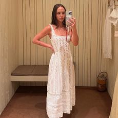 Makenna wears a white lace maxi dress.