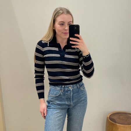 Florrie wears a navy striped sweater, blue jeans