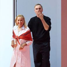 Miuccia Prada and Raf Simons bowing at the SS26 Prada show.