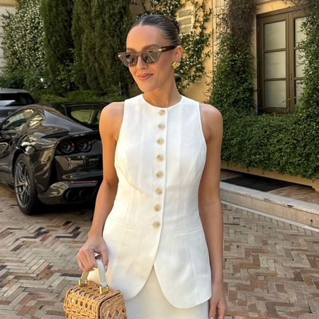 Woman wearing white linen vest and linen shorts in Europe.